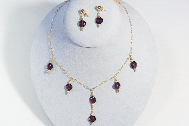 14k gold chain and accents with faceted rhodolite coins.   Necklace $325  and earrings  $125